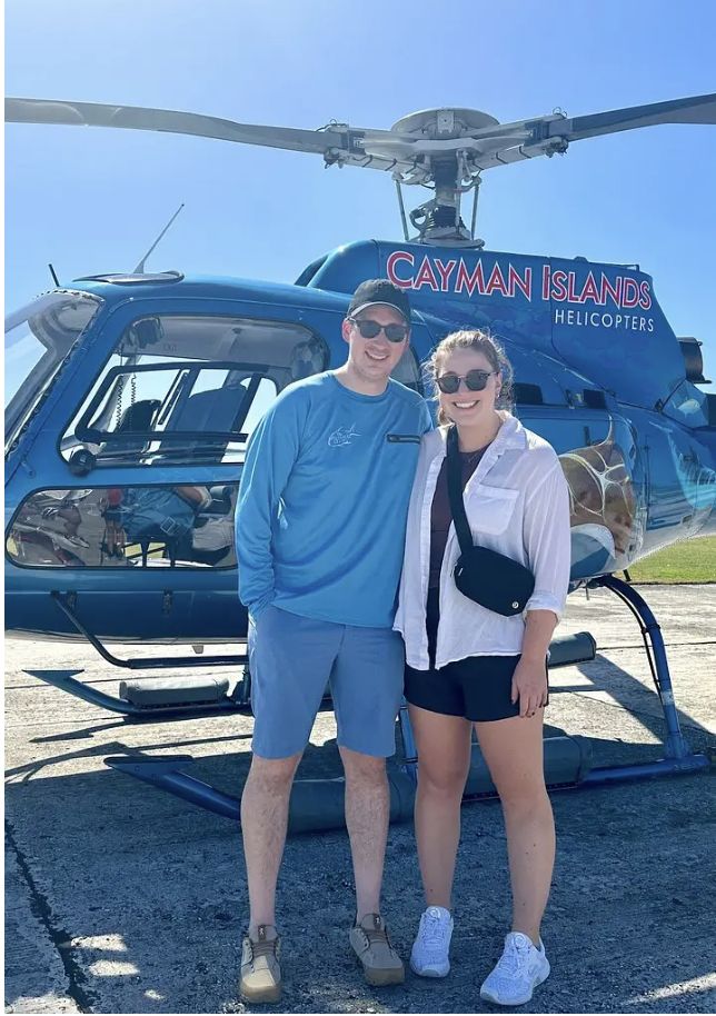 A couple in front of the helicopter